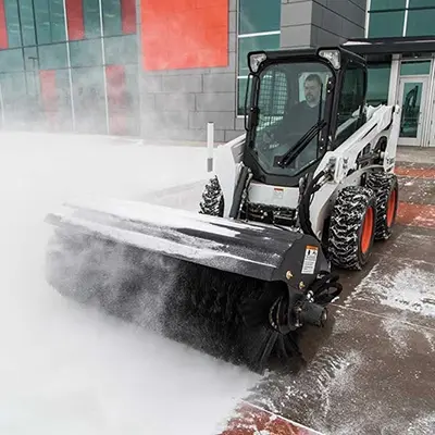 skid loader with brush implement